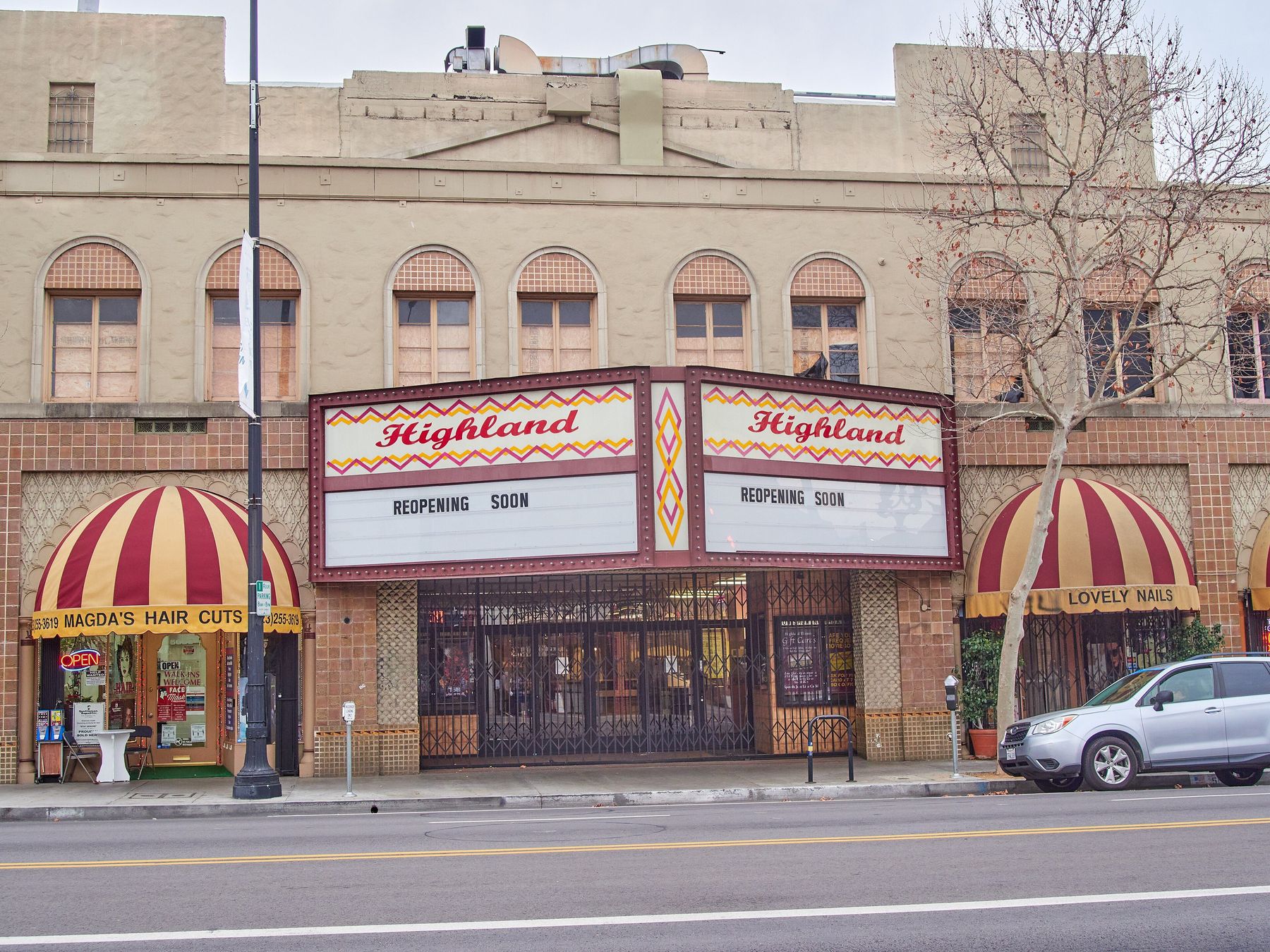 The Highland Theatre marquee and neighboring storefronts on North Figueroa Street